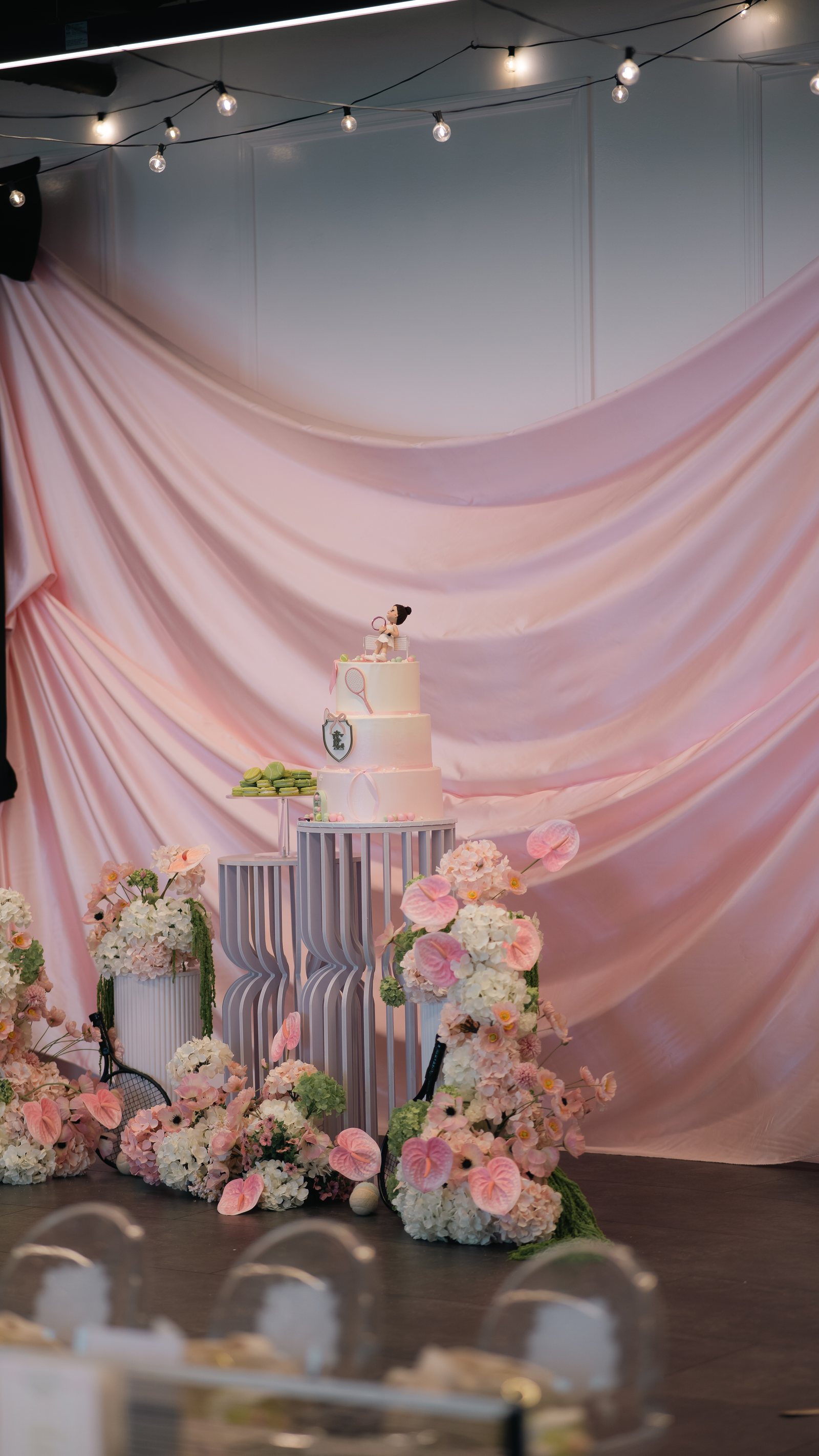 A cake and floral display against soft drapery at Trellis 925