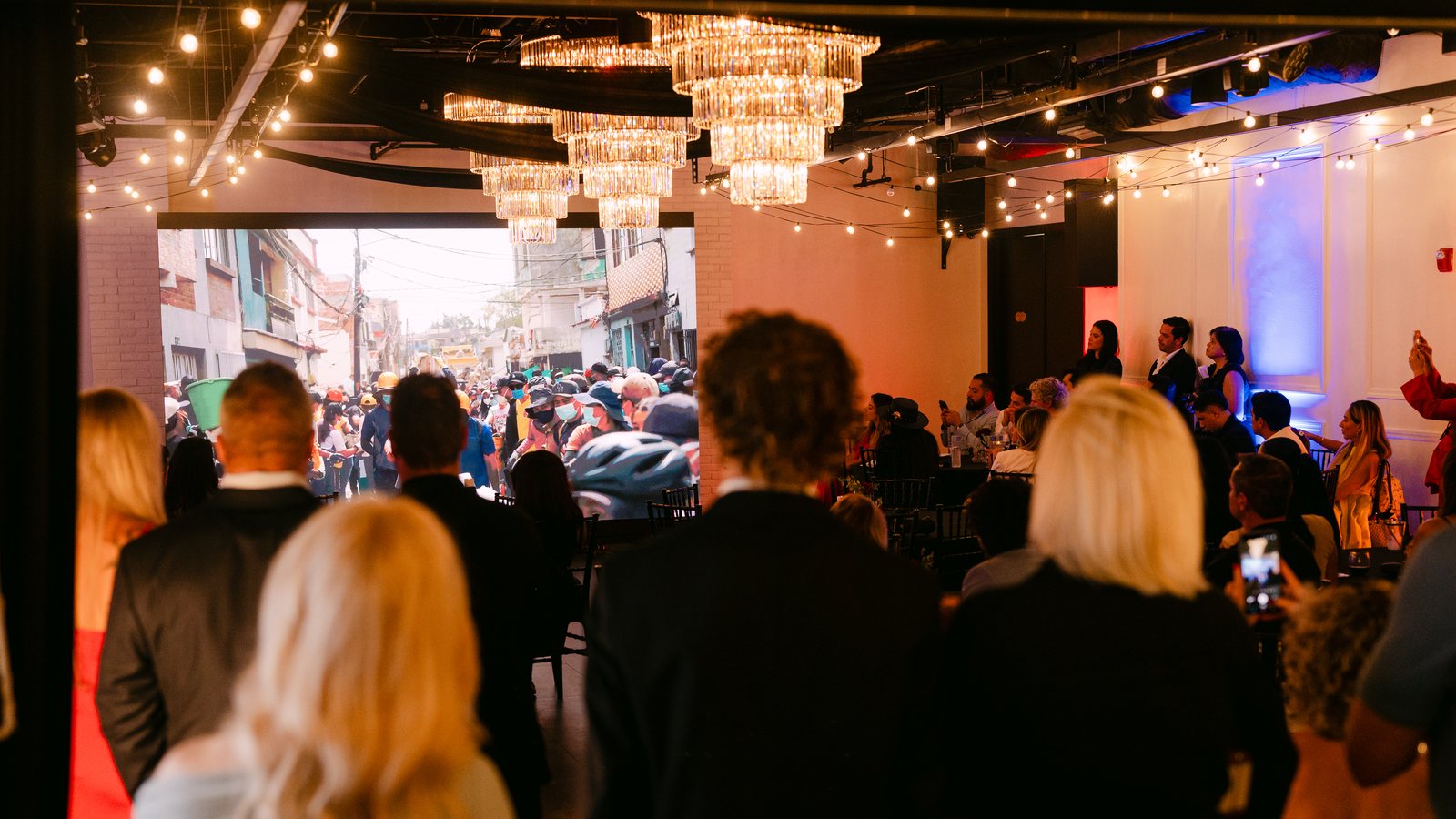 Guests gathered beneath the chandeliers at Trellis 925