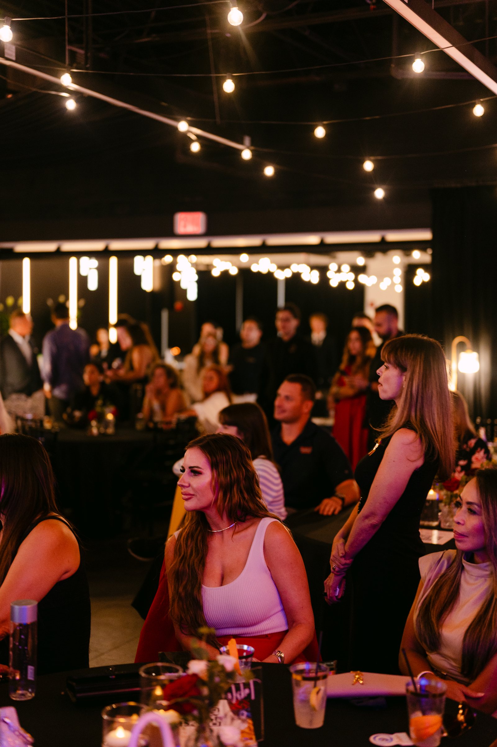 An evening gathering under string lights at Trellis 925