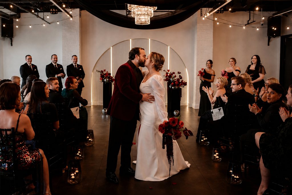 A couple’s first kiss during their ceremony at Trellis 925