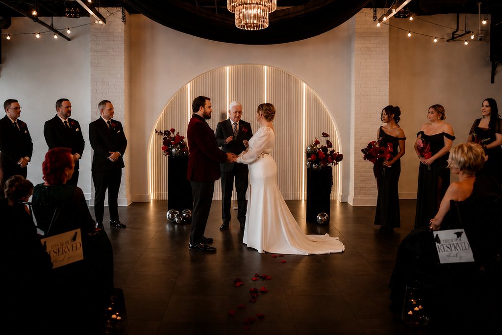 A couple exchanging vows at Trellis 925